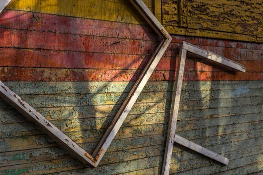 Abstract composition with a frames on old wooden wall with weathered peeling paint