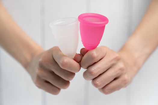 Close up of woman hand holding menstrual cup.