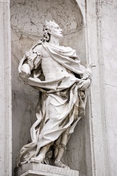 Stone carved statue of Saint Eustace. Facade of San Stae church, overlooking the Grand Canal in Venice. St Eustace was a Roman army commander who became a Christian martyr.
