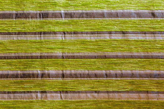 green striped synthetic woven upholstery fabric close-up texture and background