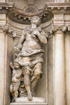 Classical style statue of a mother and child. Facade of the baroque period Scalzi church in Cannaregio, Venice. Statue on public display over 200 years, viewed from public pavement.