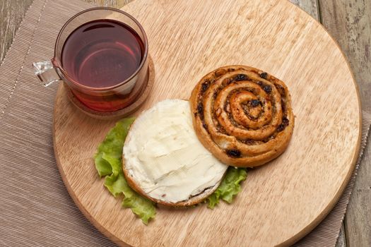 Cup and and pastry with chocolate on a wooden desk