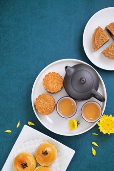 Minimal simplicity layout moon cakes on blue background for Mid-Autumn Festival, creative food design concept, top view, flat lay, copy space.