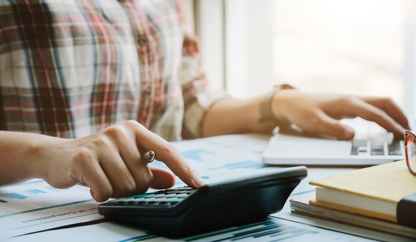 Business woman working in finance and accounting Analyze financial budget in the office.