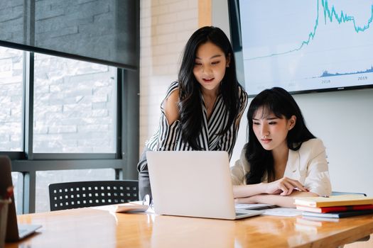 Two young asia business woman working together in modern office.