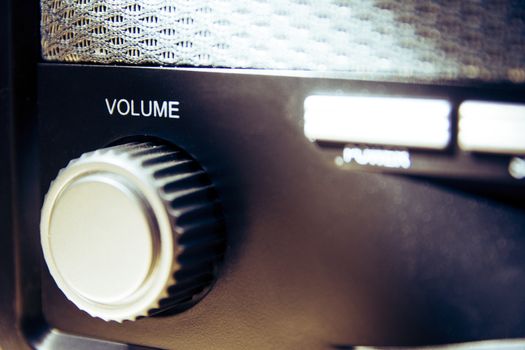 Volume wheel on an old and vintage analog radio. Creative processing for retro looks. Selective focus.