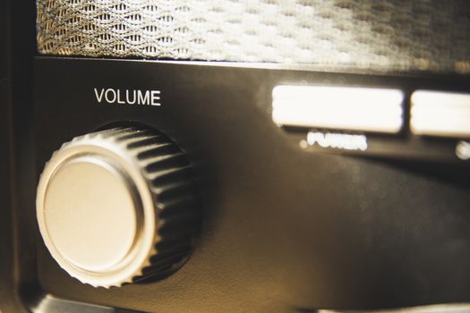 Volume wheel on an old and vintage analog radio. Creative processing for retro looks. Selective focus.