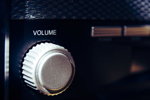 Volume wheel on an old and vintage analog radio. Creative processing for retro looks. Selective focus.
