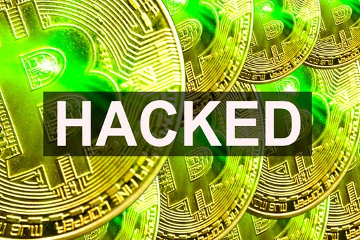 BITCOIN HACKED text on BITCOIN background. Cryptocurrency theft concept