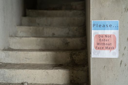 signage board showing of do not enter without face mask at industrial workplace due to coronavirus or covid-19 pandamic - concept of industry or business reopen and new normal lifestyle