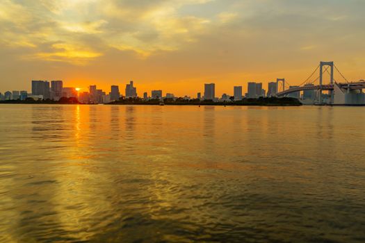 Sunset view of the city skyline and the Rainbow Bridge, in Tokyo, Japan