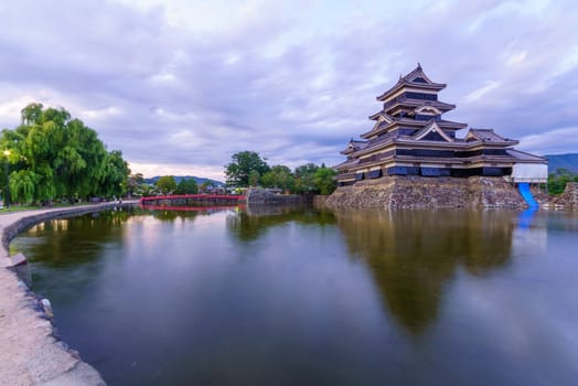 Sunset view of the Matsumoto Castle (or Crow Castle) and bridge, in Matsumoto, Japan