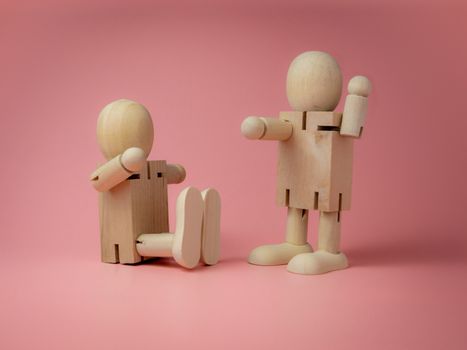 2 wooden dolls sitting and standing Talk gestures On the pink background.
Concept of social contact from wood dolls.