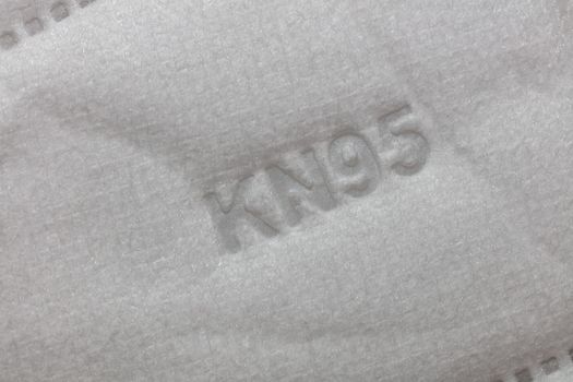 Part of KN95 standard facial mask with KN95 on it. Close-up shot. Healthcare system concept.