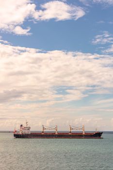 Oil tanker in Panama Canal. Clouds and blue sky as a background