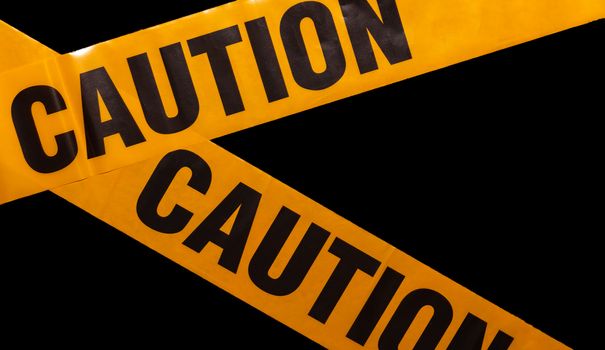 Yellow caution tapes crossing. Isolated. Black background. Protection against viruses, bacteria, and germs. Quarantine area. Police barrier.