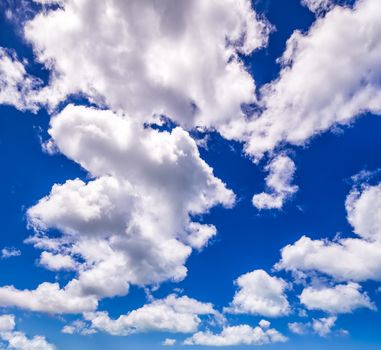 Blue sky background with fluffy white clouds beautifully shaped