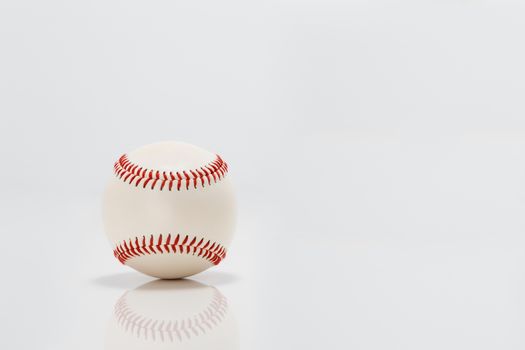 Professional baseball on white background. Isolated and reflecting in the surface below it.