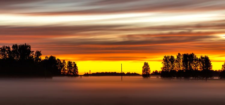 Beautiful sunset with amazing orange and yellow colors in the Russian countryside. Siberia, Altai