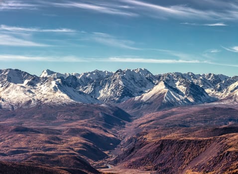 Panoramic scenic view of Northern Chuyskiy mountain range with snowy peaks and vast valley in Altai, Russia. Fall 2019