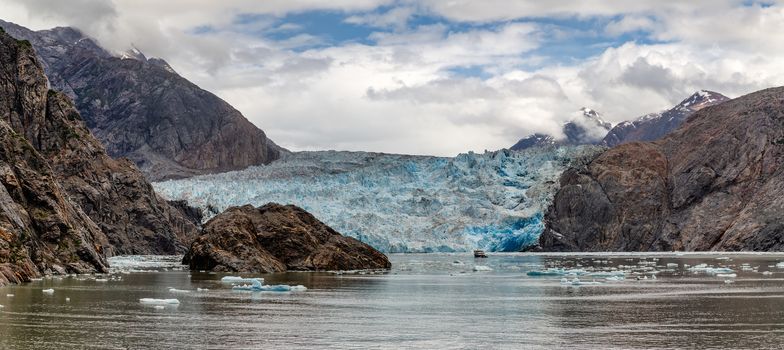 Gorgeous Panoramic View of Sawyer Glacier with a Boat Anchored next to it in Alaska's Tracy Arm Fjords Terror Wilderness