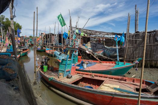 Thai small fishing boats have docked at fishing village at day time.