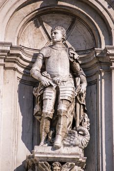 Stone statue of the former patron saint of Venice, Saint Theodore. Standing on top of the dragon he is reputed to have killed. Facade of Santa Maria della Salute church in Dorsoduro, Venice.