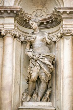 Statue of a beautiful woman representing a virtue. Facade of the baroque Scalzi church in in Cannaregio, Venice, Italy.