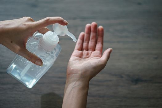 Woman washing hands with alcohol gel or sanitizer gel. corona virus or Covid-19 protection.