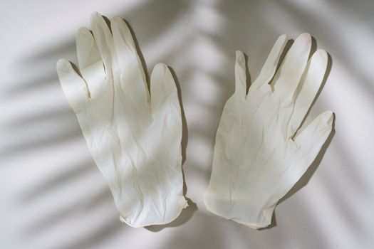 Pair of white latex medical gloves