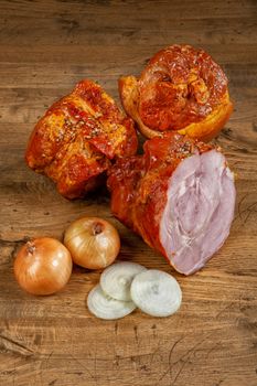 Ham sausage and onions on a wooden desk