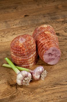 Ham sausage and garlic on a wooden desk