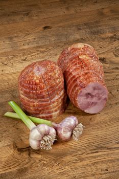 Ham sausage and garlic on a wooden desk