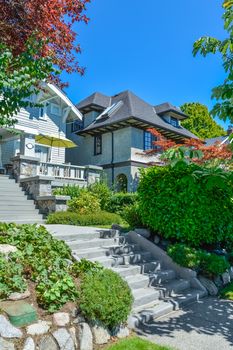 Concrete stairway to main entrance of residential house over the front yard