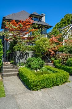 Delicately landscaped front yard of residential house