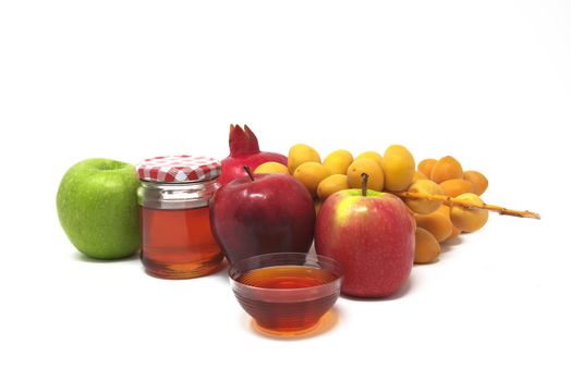 Rosh Hashanah, Jewish New Year, Traditional Symbols, Honey in a glass jar, Pomegranates, Dates, Red And Green Apples. Isolated On A White Background