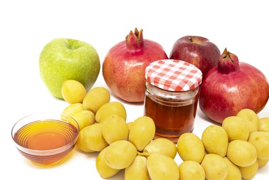 Rosh Hashanah, Jewish New Year, Traditional Symbols, Honey in a glass jar, Pomegranates, Dates, Red And Green Apples. Isolated On A White Background