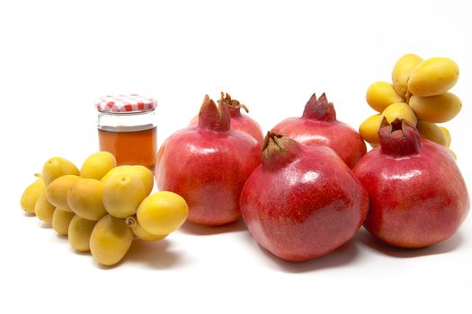 Rosh Hashanah, Jewish New Year, Traditional Symbols, Honey in a glass jar, Pomegranates, Dates. Isolated On A White Background