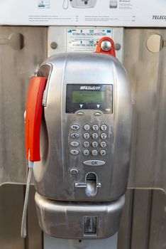 terni,italy august 08 2020:public telecom phone booth on a pedestal in the city