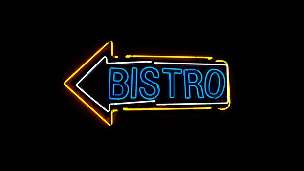 Bistro neon sign in night and black background.