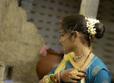 Indoors gorgeous girls with white jasmine flowers garland on her hairs, fashion model