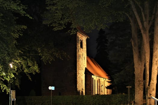 A church in the evening with trees in the foreground