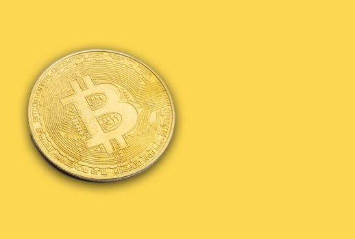 BITCOIN Cryptocurrency on yellow background. Cryptocurrency concept
