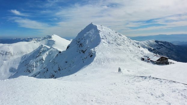 Winter panorama of Chopok mountain covered with snow in Jasna ski resort on beautiful sunny day. Low Tatras, Slovakia