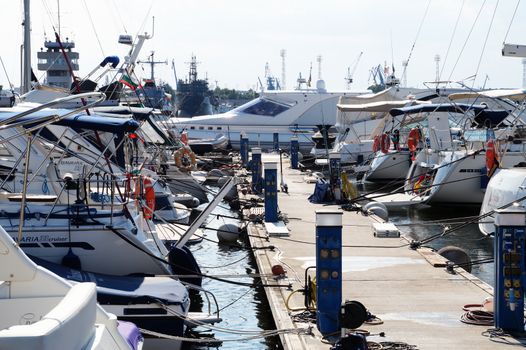 Varna, Bulgaria - August, 01,2020: white yachts moored in the port against the backdrop of the sunset sky