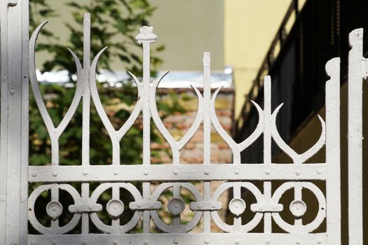 fragment of openwork white forged fence