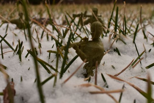 A Toy Soldier Taking Aim and Ready to Fight in Knee-Deep Snow