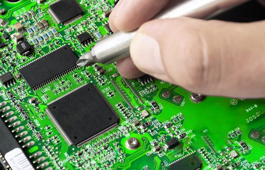 repairing a printed circuit board. Micro technology and repairs. Electronic components and conductors