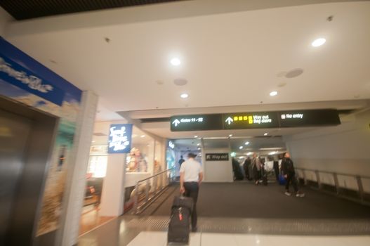 Blurry scene of rushing to follow a flight captain to pass the scanner gate in the airport