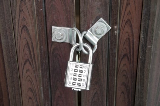 Wooden door locked by silver numpad